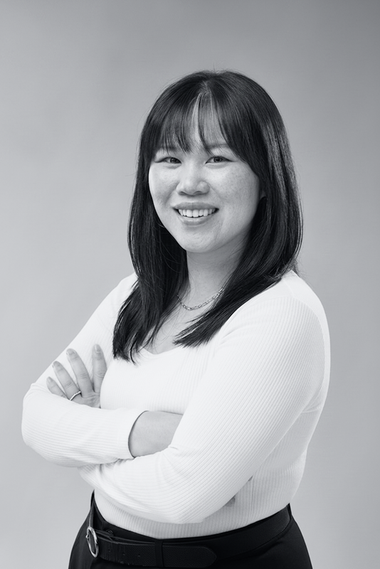black and white photo of diana luong. A woman smiling. 